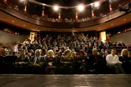 Widownia teatru pełna widzów, zastanawiających się, gdzie najlepiej siedzieć w teatrze, by mieć najlepszy widok.