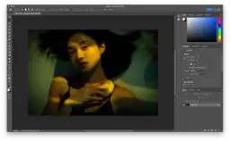 Kobieta z jabłkiem w dłoni, oświetlona żółtym światłem. Widać panel Photoshopa, gdzie można zobaczyć, jak rozciągnąć obraz.