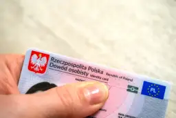 Dłoń trzyma polski dowód osobisty. Czy imię z bierzmowania jest w dowodzie? To pytanie nurtuje wielu Polaków.