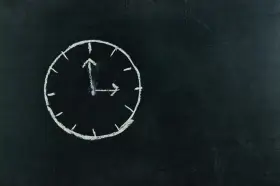Zegar na tablicy, jakby odmierzał czas do ostatnich pieśni pogrzebowych.