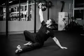 Mężczyzna wykonuje ćwiczenia na siłowni z kettlebell.