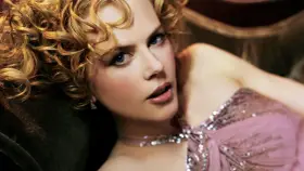 Nicole Kidman w różowej, cekinowej sukni, z burzą blond loków. Jej spojrzenie przywodzi na myśl jej niezapomniane role w filmach.