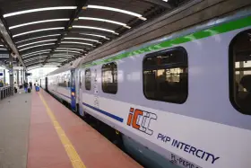 Pociąg PKP Intercity na peronie, z widocznymi oknami i logo.