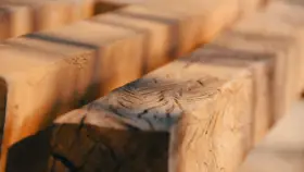 Close-up of rough-hewn wooden beams, evoking the question: was Jesus a carpenter?