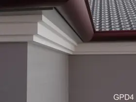 Elegancki gzyms zdobi narożnik budynku, harmonizując z dachówką i rynną.