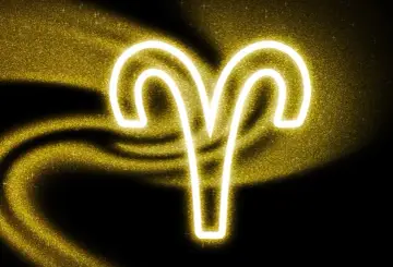 Symbol Barana, 27 marca znak zodiaku, lśni złotym blaskiem na tle czerni i brokatu.