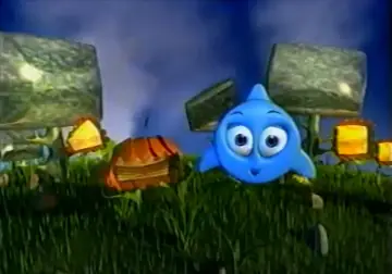 Niebieski, kreskówkowy stworek Kropek z TVN w bajkowej scenerii, wśród trawy i dziwnych budowli.