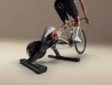 A cyclist rides indoors on a Wahoo Kickr Core 2 trainer, simulating an outdoor ride with realistic resistance.