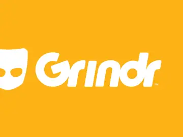Logo Grindr na żółtym tle. Aplikacja randkowa dla gejów, podobna do Tindera.