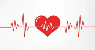 Czerwone serce z linią EKG symbolizującą zdrowe, prawidłowe tętno.
