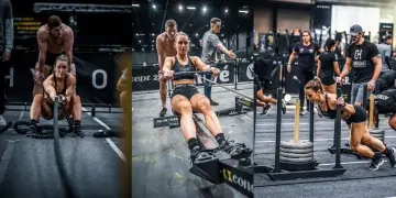 Kobieta wykonuje ćwiczenia siłowe, w tym wiosłowanie i przepychanie sanek. To część wyzwania Hyrox, które sprawdza wszechstronność sportowców.
