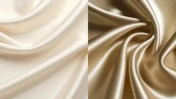 Zwei Stoffbahnen in Creme und Gold, die die glatte, glänzende Textur von Satin zeigen.