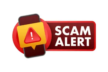 Ostrzeżenie przed oszustwem (scam co to) na telefonie. Czerwony trójkąt z wykrzyknikiem na żółtym tle.