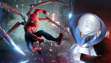 Spider-Man en acción, con sus tentáculos mecánicos desplegados, junto al trofeo platino de Spider-Man 2.