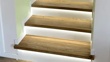 Nowe schody z drewna dębowego z podświetleniem LED. Zobacz, jak zamontować listwy przy schodach, by uzyskać nowoczesny efekt.