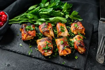 Bombette pugliesi succulente, avvolte in pancetta croccante e guarnite con prezzemolo fresco. Un assaggio di Puglia!