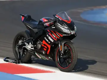 Czarna Aprilia RS 125 z czerwonymi akcentami na torze, gotowa do bicia rekordów w przyspieszeniu 0-100.