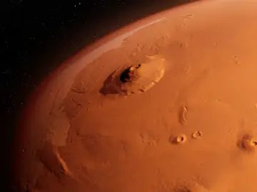 Widok z kosmosu na Marsa, z dominującym masywem Olympus Mons. Czerwona planeta w blasku gwiazd.