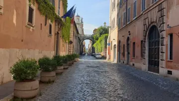 Urokliwa, brukowana uliczka w Rzymie z łukiem i zielenią. Odkryj nieoczywiste atrakcje Wiecznego Miasta.