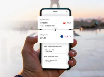 Dłoń trzyma smartfon z aplikacją kantoru. Widoczny kurs wymiany PLN na EUR.