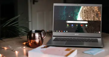 Acer Chromebook na drewnianym blacie, obok miedzianego kubka i światełek. To idealne urządzenie, jeśli zastanawiasz się, chromebook co to.
