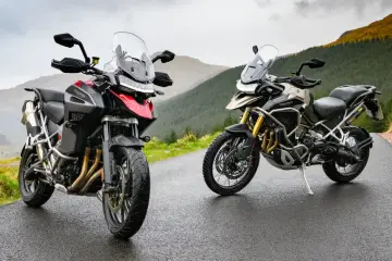 Dwa motocykle Triumph Tiger 1200 na mokrej drodze w górach. Poznajcie dane techniczne tych potężnych maszyn.