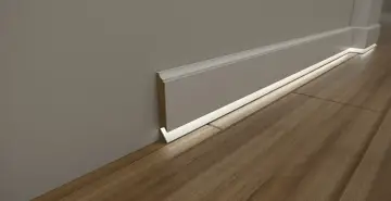 Nowoczesna listwa przypodłogowa podświetlana subtelnie rozjaśnia drewnianą podłogę, tworząc przytulną atmosferę.