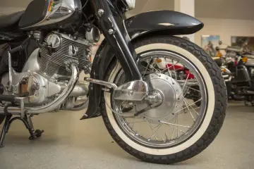 Błyszczący silnik i białe opony klasycznego motocykla Honda Dream 125.