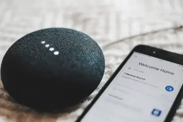 A smart speaker and phone display "Welcome Home" and "1 device found," showcasing modern iot design for a connected home.