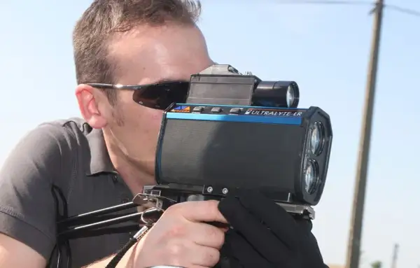 Un homme utilise un nouveau radar camera Ultralyte LR pour mesurer la vitesse.