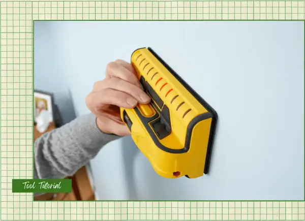 Learn how to use a stud finder to locate wall studs for secure mounting. This yellow tool is pressed against the wall.