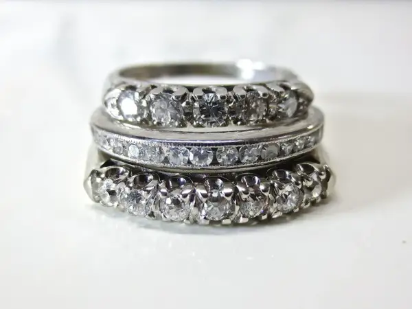 Tres anillos apilados, engastados con diamantes. El platino es un metal precioso que realza el brillo de las gemas.