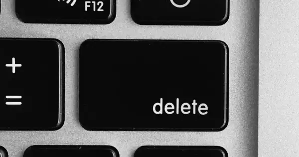 Close-up of a laptop keyboard showing the '+' and '=' keys, and the prominent 'delete' key.