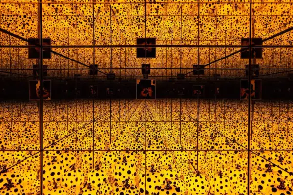 A dazzling infinity room with crystal bridges, bathed in golden light and adorned with Yayoi Kusama's iconic polka dots, creating an endless, mesmerizing spectacle.