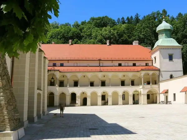 Zamek Sucha Beskidzka z arkadowym dziedzińcem i zieloną wieżą. Spacer po dziedzińcu z psem.