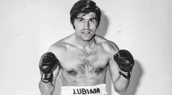 Boxer Nino Benvenuti, a powerful figure with boxing gloves on, ready to fight.