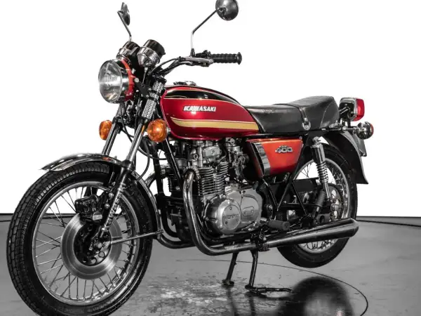 Clásica Kawasaki 400 antigua, roja y dorada, con motor expuesto y detalles cromados. Un icono de los 70.