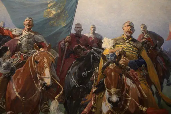 Józef Brandt obrazy: husaria na koniach, z chorągwią i w zbrojach, gotowa do walki. Dynamiczna scena historyczna.