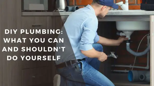 Man working on sink plumbing, part of a DIY bathroom remodel guide.