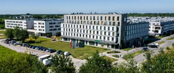 Nowoczesny waw airport hotel z parkingiem i zielonym otoczeniem.