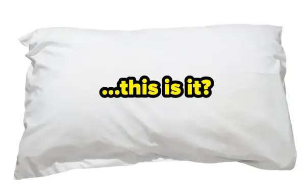 A white pillow with the text "...this is it?" in yellow and black. It makes you wonder, how many pillows do you sleep with?