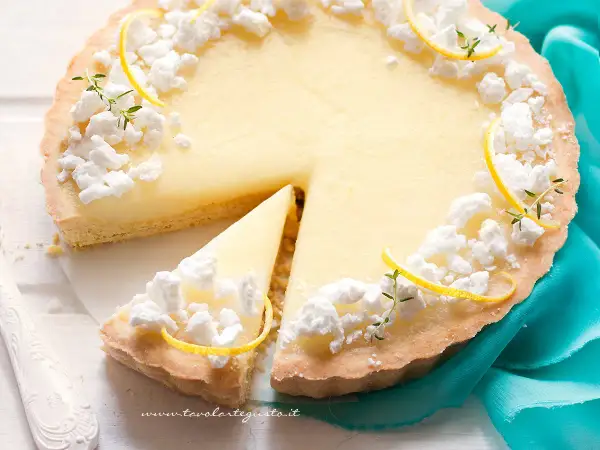 Deliziosa crostata al limone con meringhe e scorzette, una fetta è già stata servita.