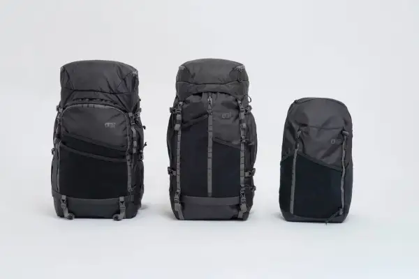 Trois sacs à dos noirs de tailles différentes, du plus grand au plus petit, alignés sur fond blanc. Le **taille sac à dos** varie pour s'adapter à tous les besoins.