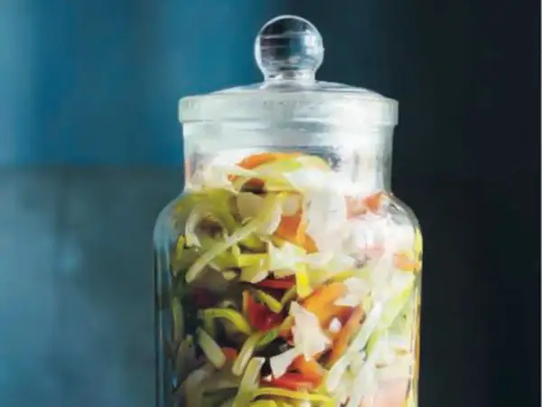 En glasburk fylld med strimlad vitkål, morötter och purjolök. En perfekt 3 veckors sallad som väntar på att bli uppäten.