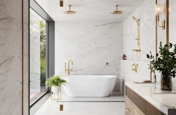 Luxurious bathroom with white marble ceramic tile on shower walls, a freestanding tub, and gold fixtures.