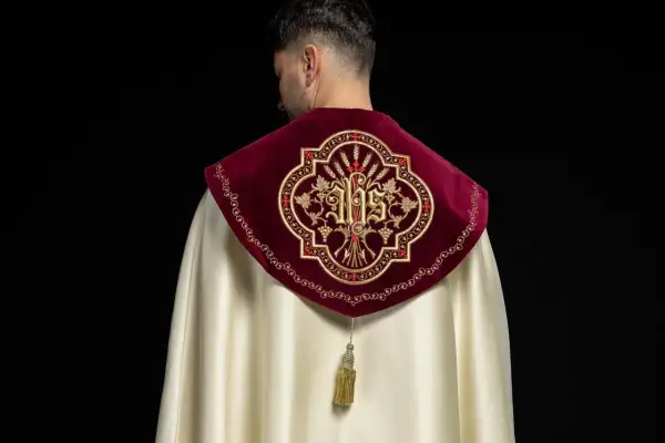 Szata liturgiczna z haftem IHS i kłosem zboża na aksamitnym kołnierzu.