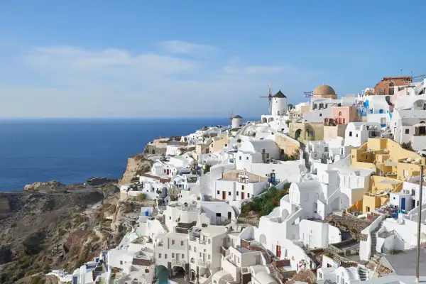 Malownicze białe domy Santorini, wiatraki i błękitne morze. Idealne miejsce na wycieczki z kos.