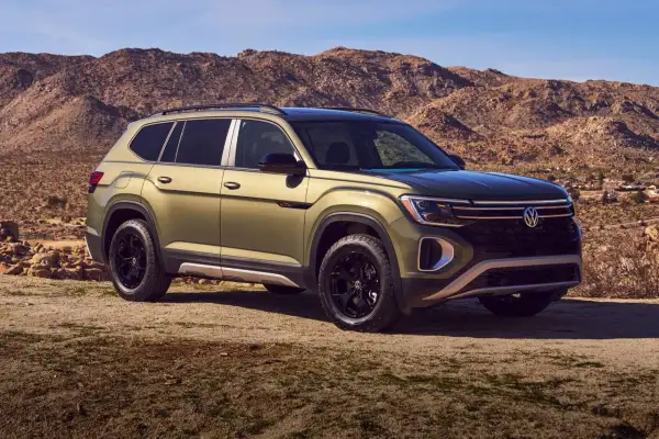 Zielony VW Atlas na tle pustynnego krajobrazu.