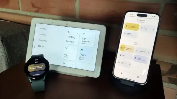 Zegarek z Wear OS i smartfon sterują inteligentnym domem. Na ekranach widać sterowanie oświetleniem i roletami w salonie.