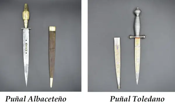 Dos puñales, uno Albaceteño con mango de hueso y otro Toledano con grabados dorados, son armas históricas.